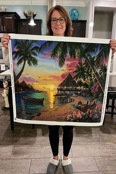 Collector placing drills on a diamond painting